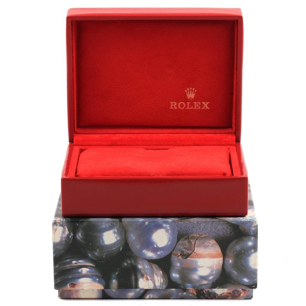 This image shows an open red watch box for a Rolex Datejust 79174 Women
s Stainless Steel Black Dial 79174 Women
s Stainless Steel Black Dial, highlighting its interior.