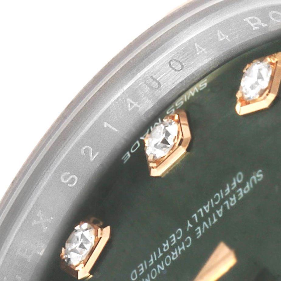 This close-up image of a Rolex Datejust 279171 Women's Steel and Gold (two tone) Green Dial 279171 Women's Steel and Gold (two tone) Green Dial watch shows the rim of the face with diamond hour markers.