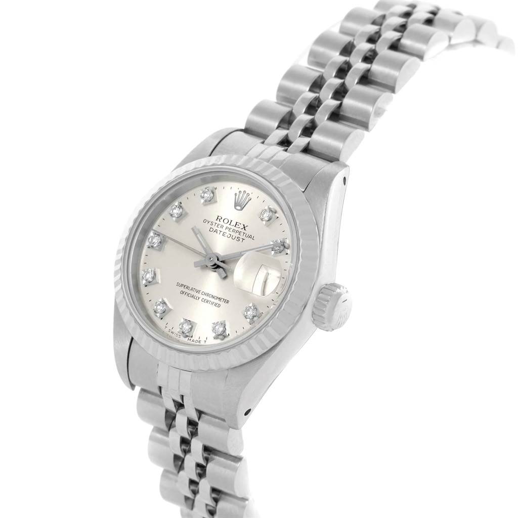 The Rolex Datejust 69174 Women
s Stainless Steel Silver Dial 69174 Women
s Stainless Steel Silver Dial watch is shown at a tilted angle, highlighting its face, bezel, crown, and metal bracelet.