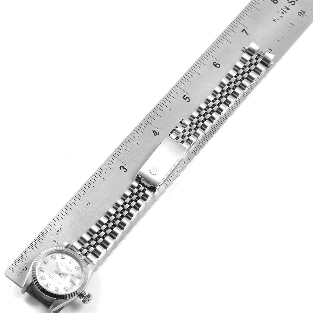 The image shows a Rolex Datejust 69174 Women
s Stainless Steel Silver Dial 69174 Women
s Stainless Steel Silver Dial watch laid flat beside a ruler, highlighting its bracelet length.