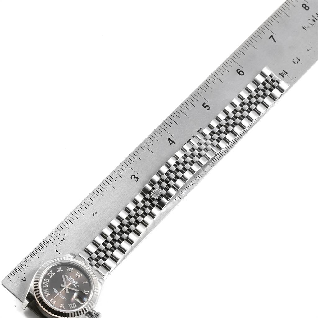 The image shows the face and bracelet of a Rolex Datejust 7SE14403 Women
s Stainless Steel Grey Dial 7SE14403 Women
s Stainless Steel Grey Dial watch, with a ruler for measurement.