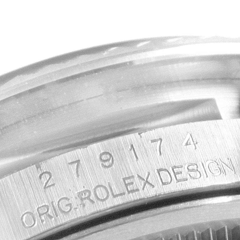This close-up image shows the side view of a Rolex Datejust 7SE14403 Women
s Stainless Steel Grey Dial 7SE14403 Women
s Stainless Steel Grey Dial watch case, highlighting the engravings on the watch
s bezel.