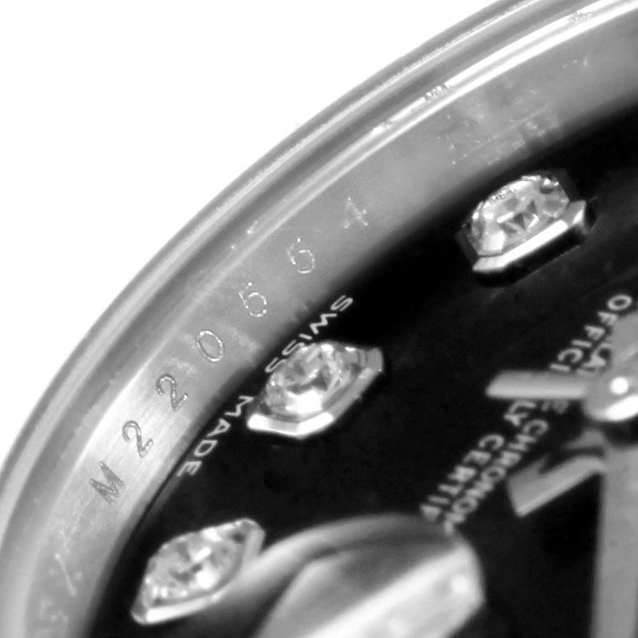 This close-up image shows the dial, diamond hour markers, and part of the bezel with serial engraving of the Rolex Datejust 179174 Women
s Stainless Steel Black Dial 179174 Women
s Stainless Steel Black Dial watch.