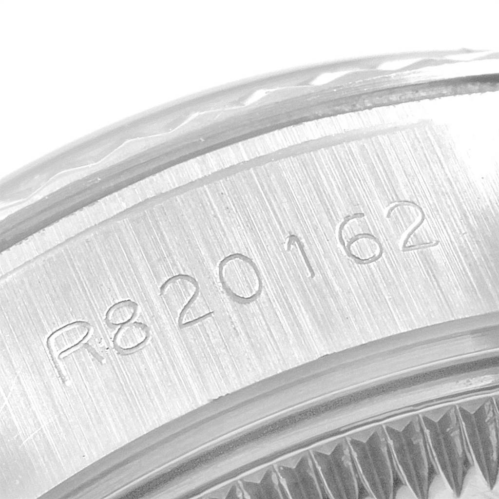 The image shows a close-up of the engraved serial number on the case of a Rolex Datejust 69174 Women
s Stainless Steel Silver Dial 69174 Women
s Stainless Steel Silver Dial watch.