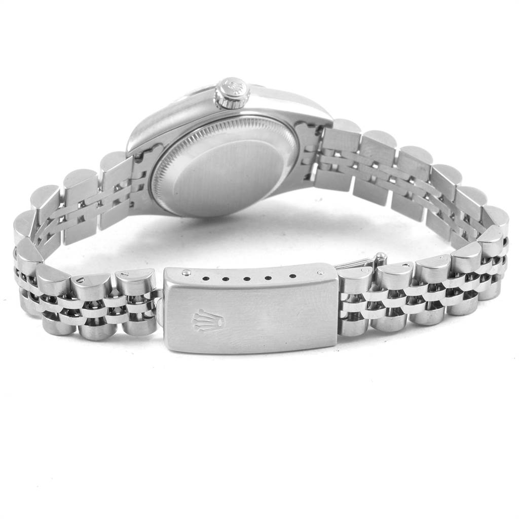 The image shows the back of a Rolex Datejust 69174 Women
s Stainless Steel Blue Dial 69174 Women
s Stainless Steel Blue Dial watch, focusing on the case, crown, and metal bracelet with a clasp.