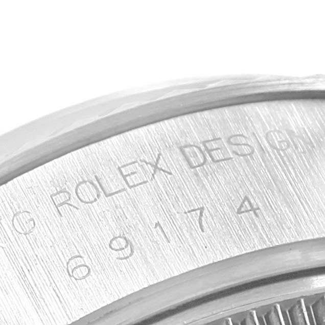 This close-up image shows the engraving and serial number on the case of a Rolex Datejust 69174 Women
s Stainless Steel Blue Dial 69174 Women
s Stainless Steel Blue Dial watch.