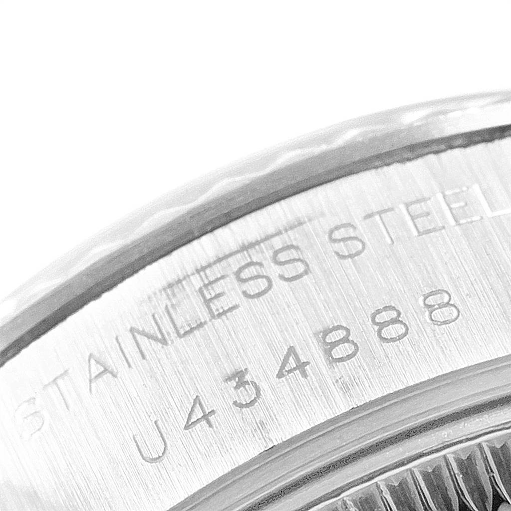 The image shows a close-up of the case back rim of a Rolex Datejust 69174 Women
s Stainless Steel Blue Dial 69174 Women
s Stainless Steel Blue Dial watch, featuring the "STAINLESS STEEL" engraving and serial number.