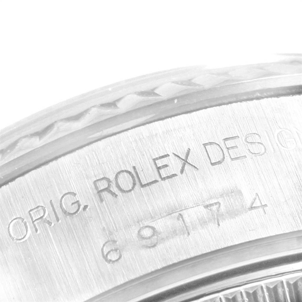 The image shows a close-up of the side engraving on the case of a Rolex Datejust 69174 Women's Stainless Steel Mother of Pearl Dial 69174 Women's Stainless Steel Mother of Pearl Dial watch.