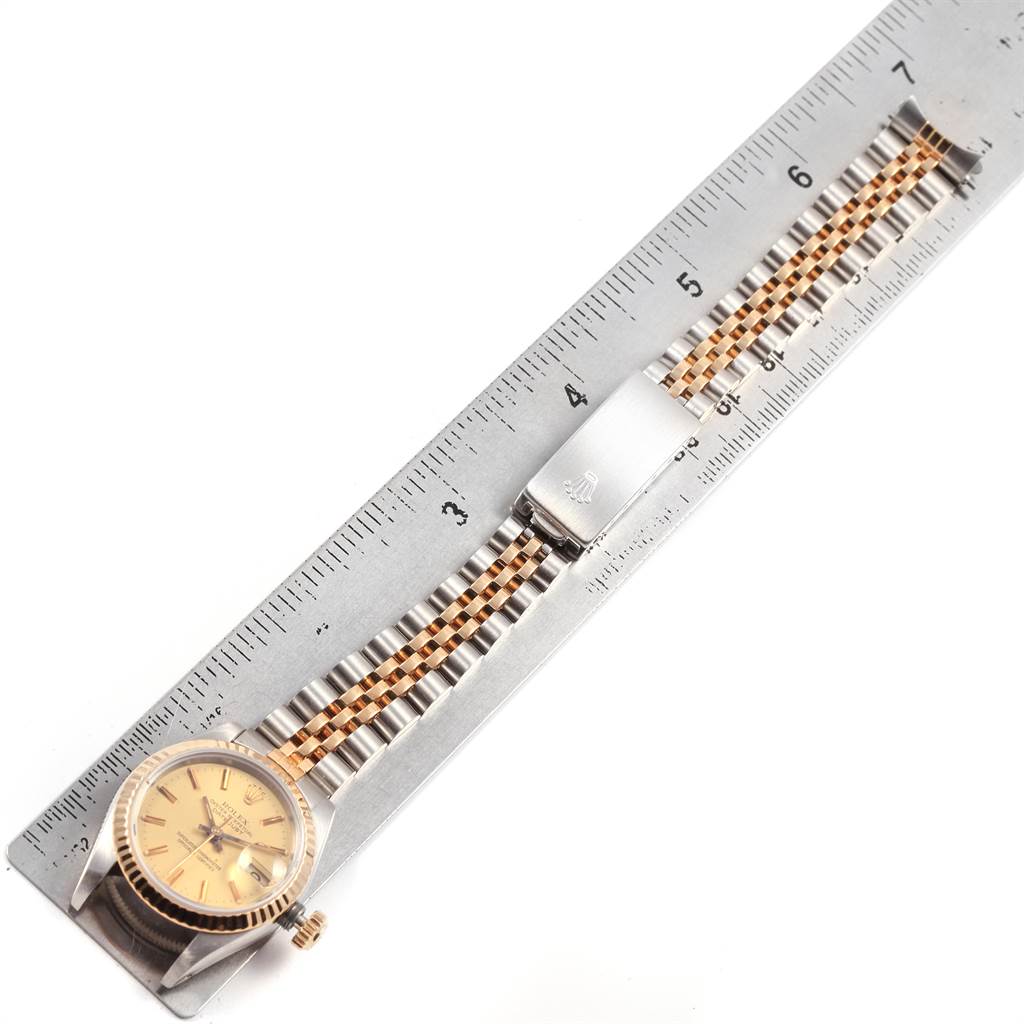 The image shows a Rolex Datejust 69173 Women's Stainless Steel Champagne Dial 69173 Women's Stainless Steel Champagne Dial model watch at a top-down angle with its bracelet laid along a ruler.
