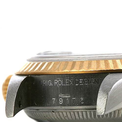This image shows a close-up side view of the bezel and lugs of a Rolex Datejust 79173 Women's Stainless Steel Black Dial 79173 Women's Stainless Steel Black Dial watch, including the engraved model number.