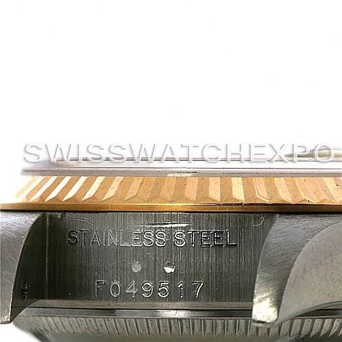 This image shows a side view of the Rolex Datejust 79173 Women
s Stainless Steel Silver Dial 79173 Women
s Stainless Steel Silver Dial watch case with the serial number and "STAINLESS STEEL" engraved on it.