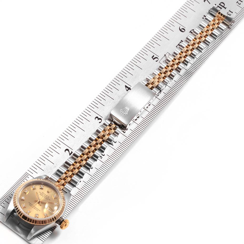 The image shows a Rolex Datejust 69173 Women's Stainless Steel Champagne Dial 69173 Women's Stainless Steel Champagne Dial watch laid flat alongside a ruler, displaying the face, bracelet, and clasp.