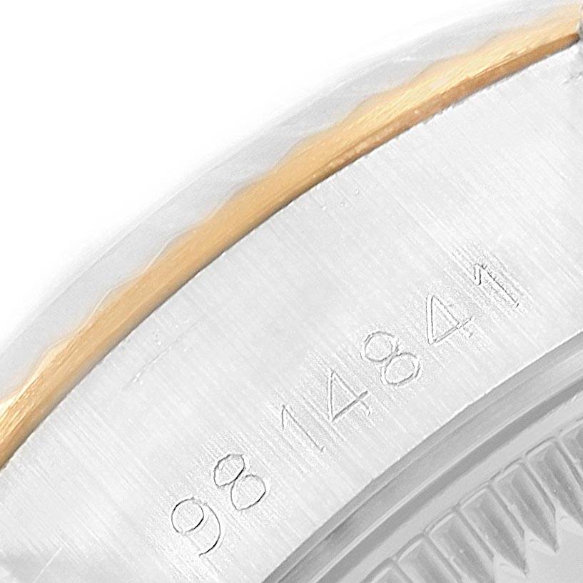 This image shows a close-up of the Rolex Datejust 69173 Women's Stainless Steel Champagne Dial 69173 Women's Stainless Steel Champagne Dial watch's serial number engraved on the side of the case.