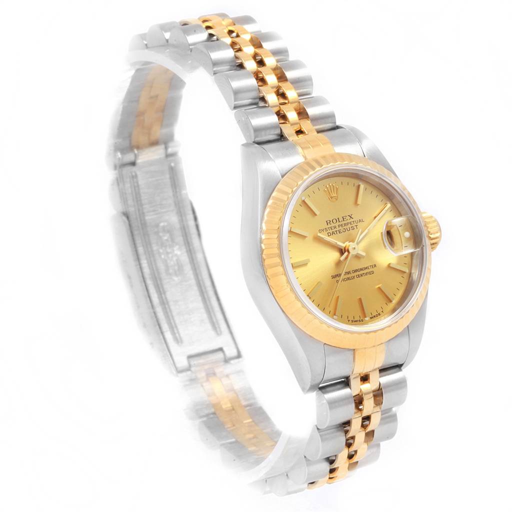 The image shows a side angle of the Rolex Datejust 69173 Women's Stainless Steel Champagne Dial 69173 Women's Stainless Steel Champagne Dial with a gold dial, fluted bezel, and a two-tone Jubilee bracelet.