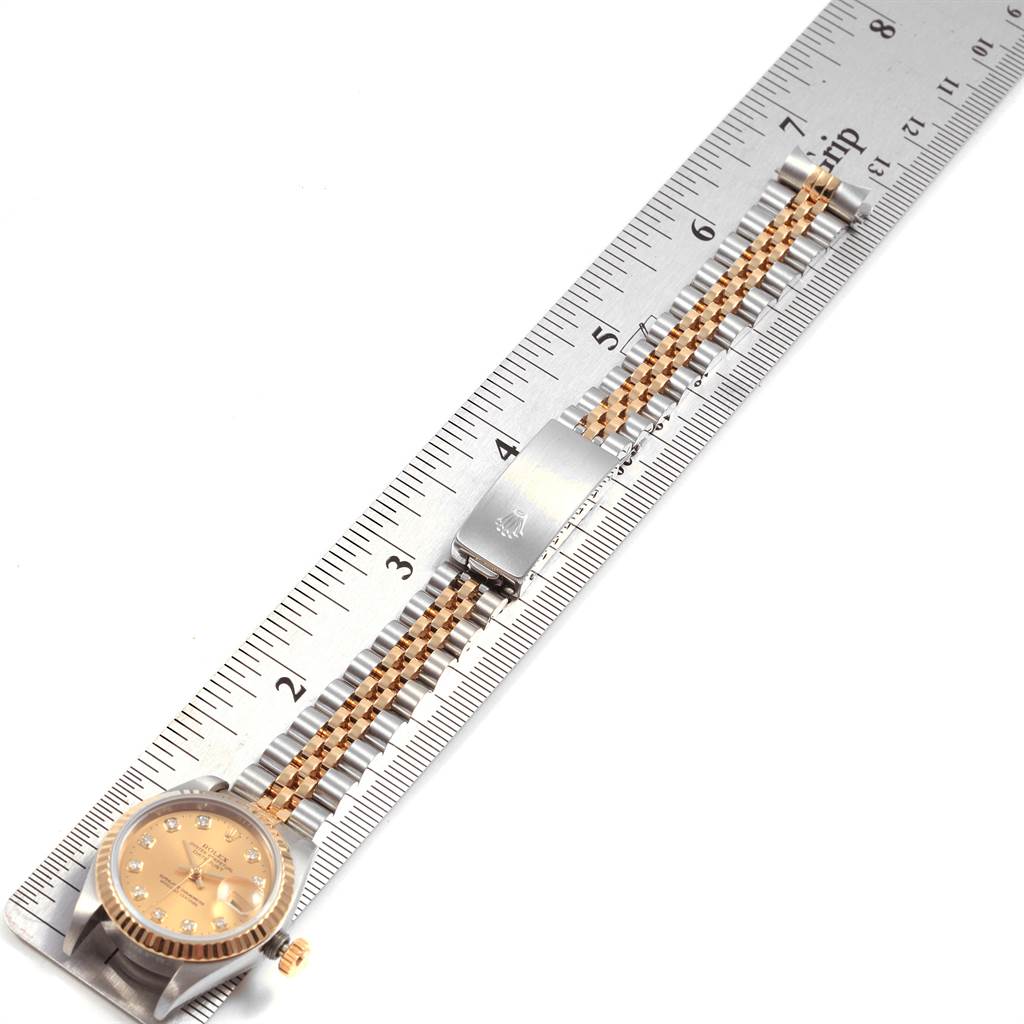 This image shows a Rolex Datejust 69173 Women's Stainless Steel Champagne Dial 69173 Women's Stainless Steel Champagne Dial watch laid flat next to a ruler, displaying its face, bezel, strap, and clasp.
