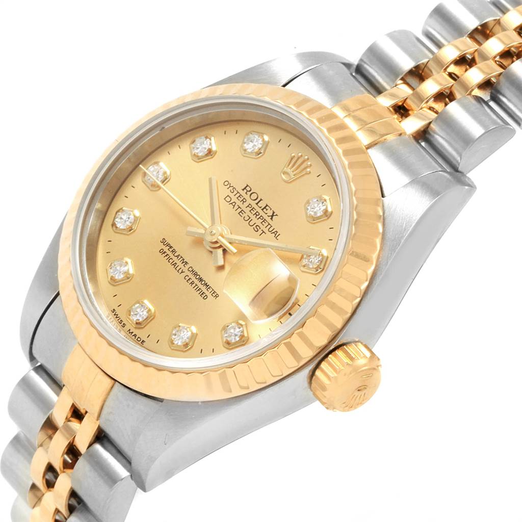 The image shows a close-up angle of the Rolex Datejust 69173 Women's Stainless Steel Champagne Dial 69173 Women's Stainless Steel Champagne Dial watch displaying its gold dial, fluted bezel, diamond markers, and jubilee bracelet.