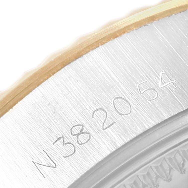 This close-up image shows part of the bezel and engraved serial number of a Rolex Datejust 69173 Women's Stainless Steel Champagne Dial 69173 Women's Stainless Steel Champagne Dial watch.