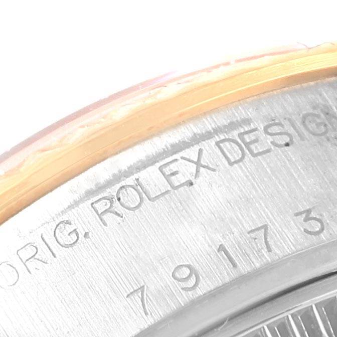 This is a close-up angle of the Rolex Datejust 79173 Women's Steel and Gold (two tone) White Dial 79173 Women's Steel and Gold (two tone) White Dial watch showing its engraved serial number on the case side.
