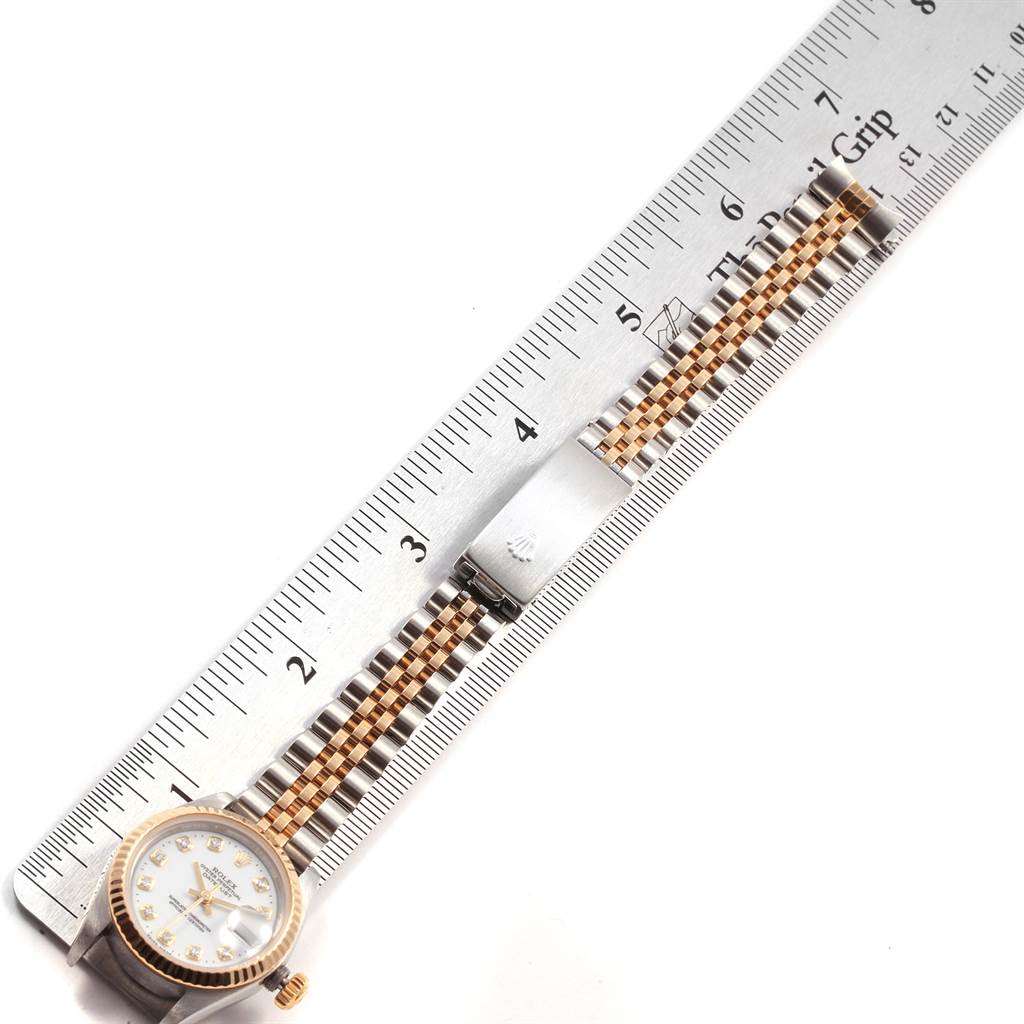 The image shows a Rolex Datejust 79173 Women's Steel and Gold (two tone) White Dial 79173 Women's Steel and Gold (two tone) White Dial watch laid next to a ruler, highlighting the bracelet and clasp from a top-down angle.