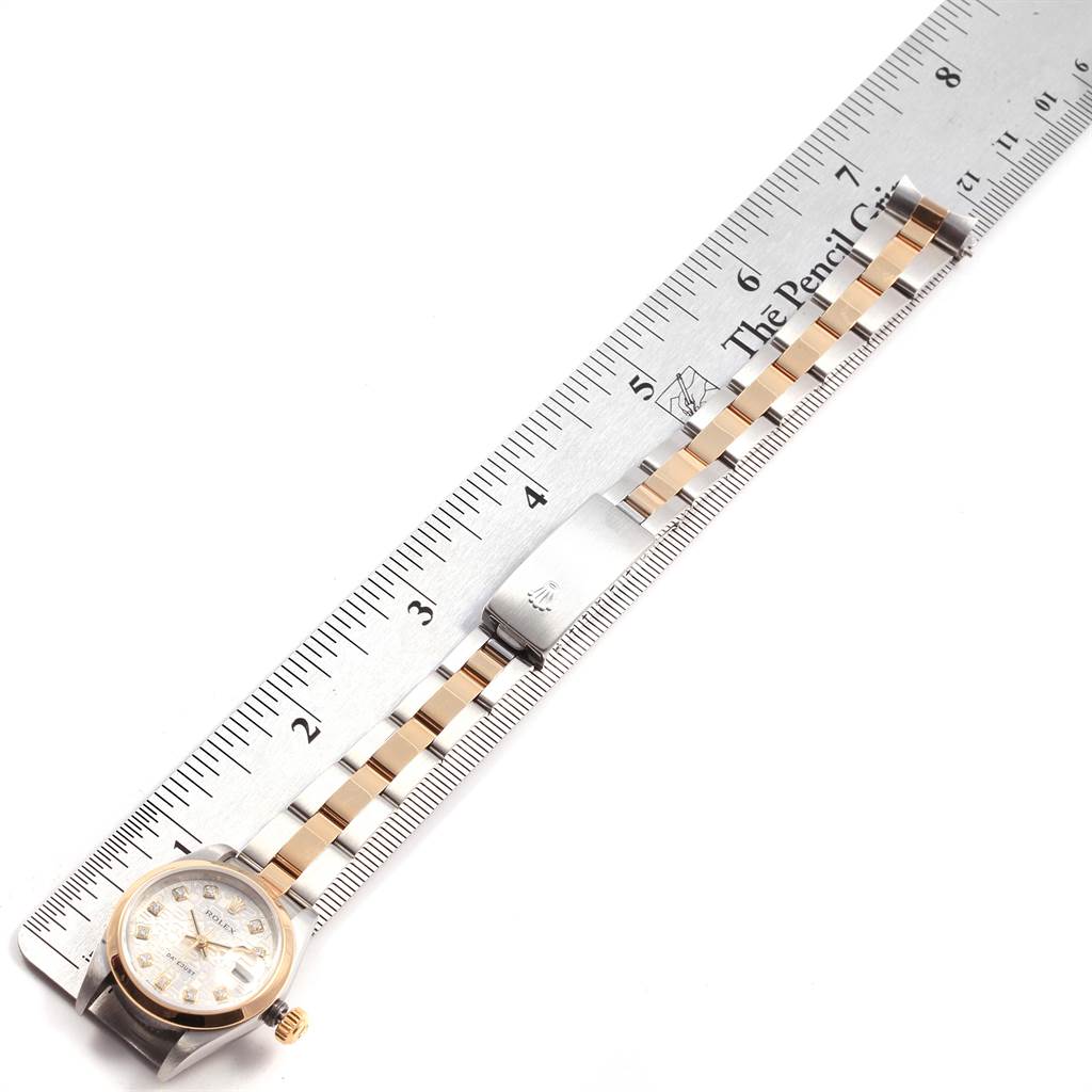 The image shows a horizontal view of a Rolex Datejust 79163 Women
s Steel and Gold (two tone) Silver Dial 79163 Women
s Steel and Gold (two tone) Silver Dial watch with a ruler measuring its length.