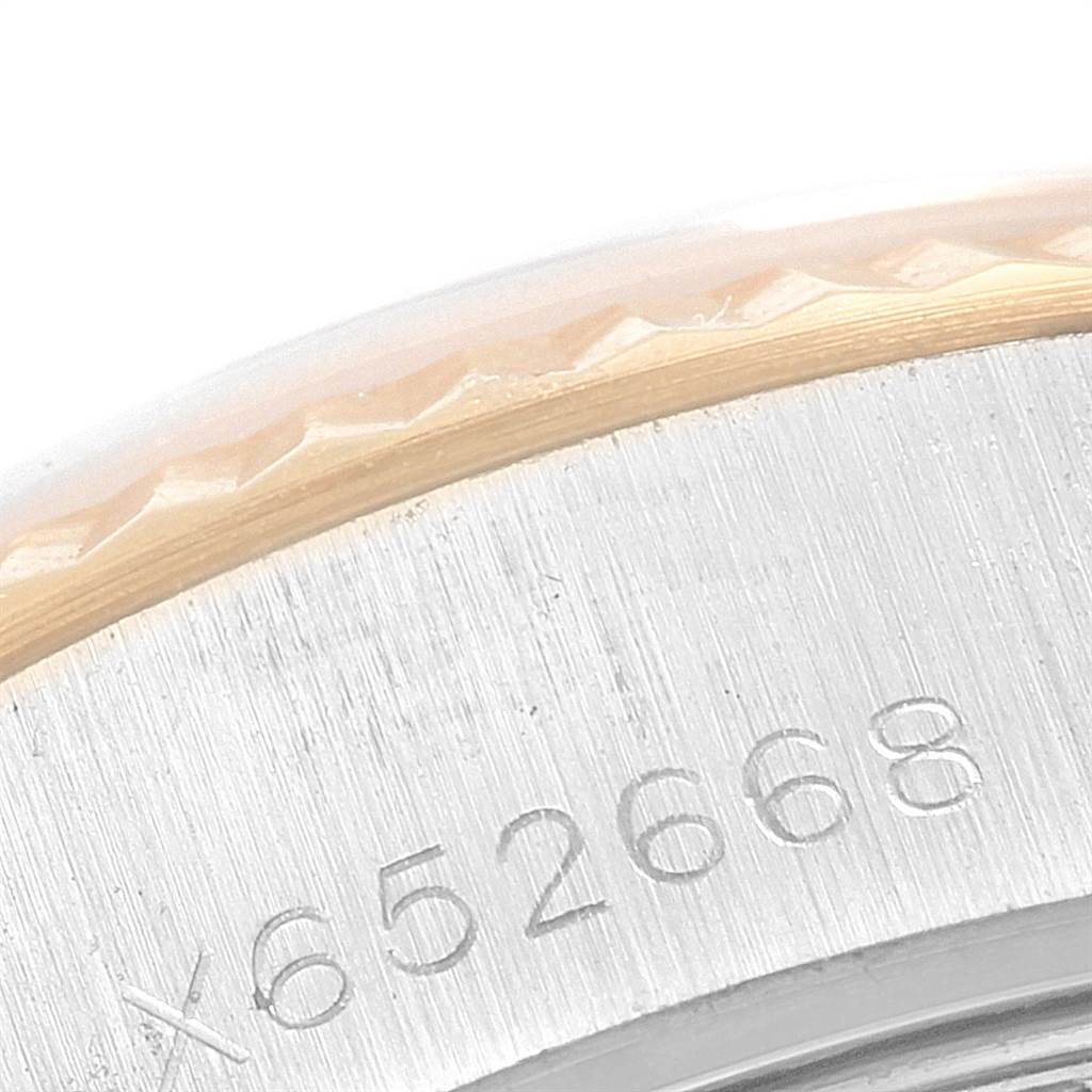 The image shows a close-up of the model number engraving and the fluted bezel on a Rolex Datejust 69173 Women's Stainless Steel White Dial 69173 Women's Stainless Steel White Dial watch.