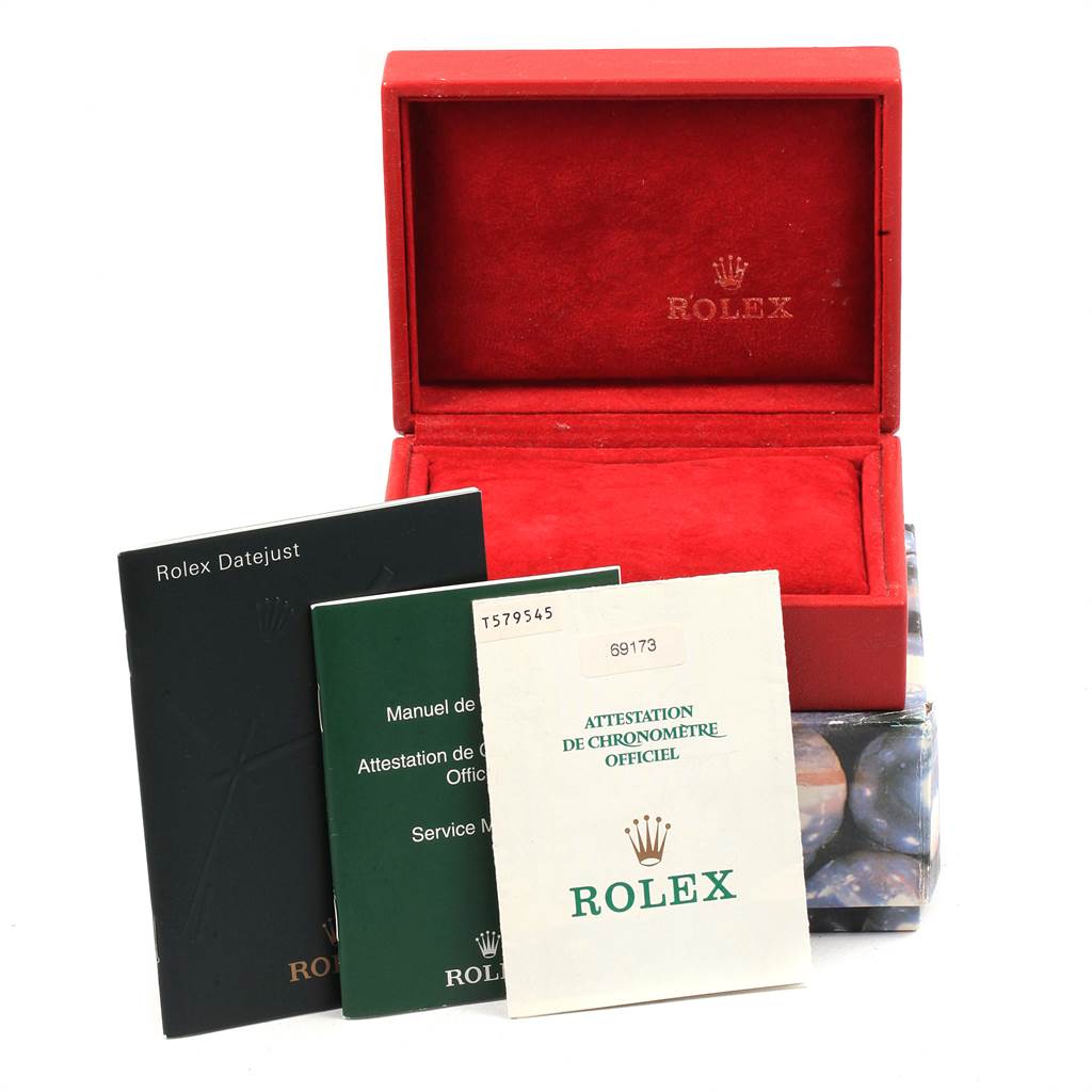 This image shows the empty red Rolex box for a Datejust model and accompanying manuals and certificates.