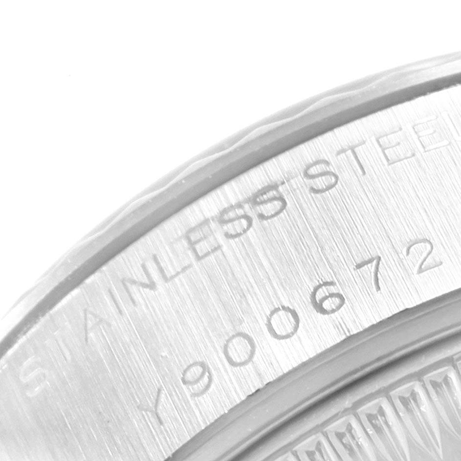 The image shows a close-up of the backside engraving of a Rolex Datejust 79174 Women
s Stainless Steel Silver Dial 79174 Women
s Stainless Steel Silver Dial watch, highlighting the serial number and "STAINLESS STEEL" text.