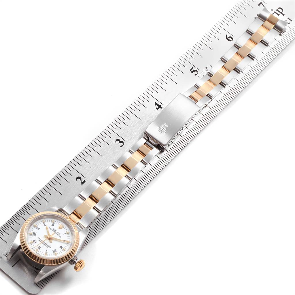 The image shows a Rolex Datejust 69173 Women's Stainless Steel White Dial 69173 Women's Stainless Steel White Dial watch with a two-tone bracelet, positioned alongside a measuring ruler.