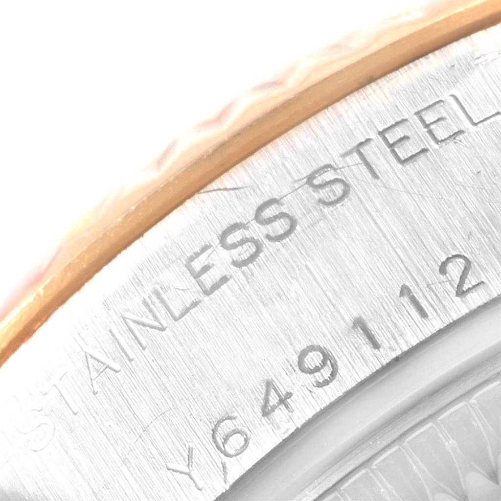 This close-up image shows the case side of a Rolex Datejust 79173 Women
s Steel and Gold (two tone) Black Dial 79173 Women
s Steel and Gold (two tone) Black Dial watch, focusing on the "STAINLESS STEEL" engraving and part of the serial number.