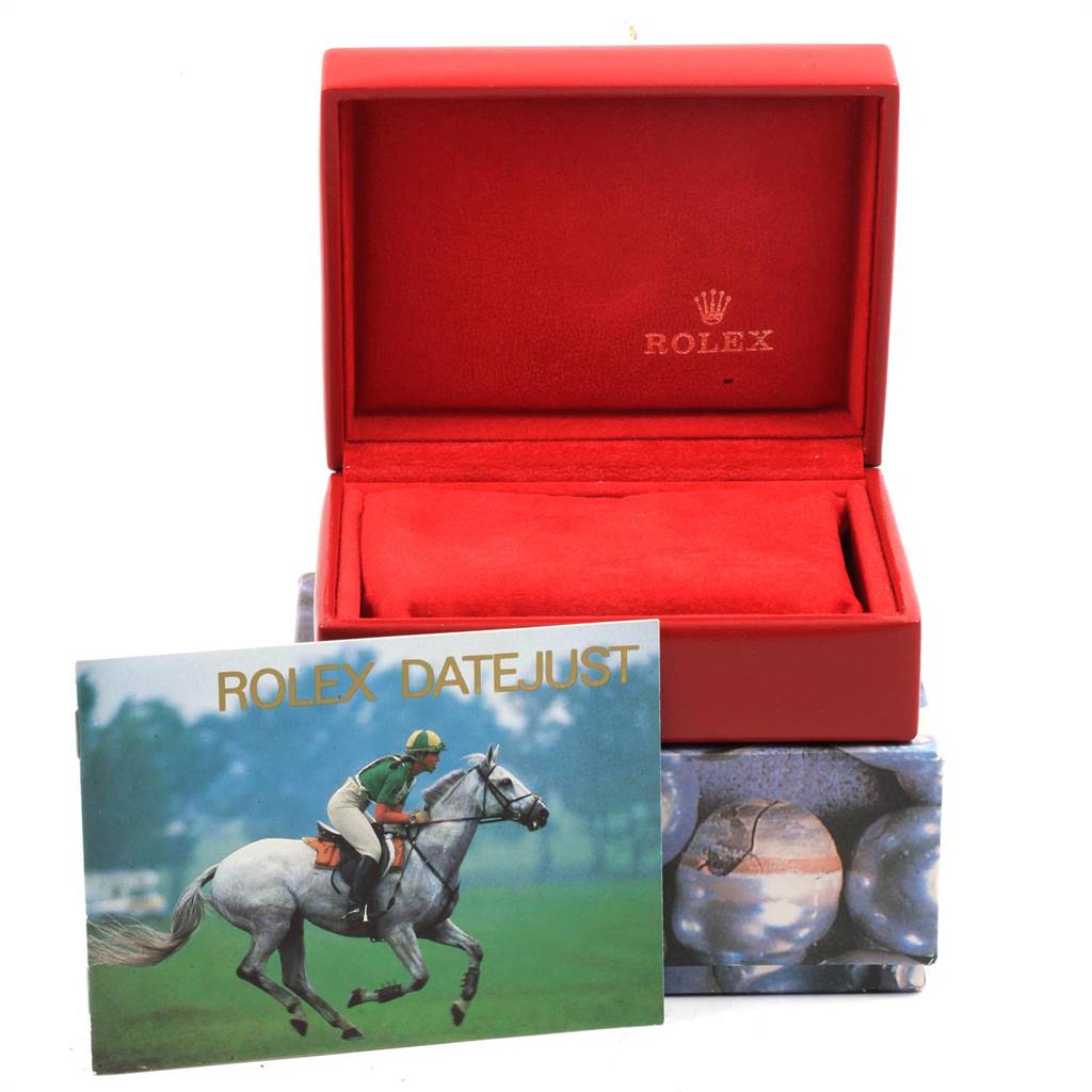 The image shows the empty red box and booklet of the Rolex Datejust 79173 Women's Steel and Gold (two tone) Black Dial 79173 Women's Steel and Gold (two tone) Black Dial model from a front angle.