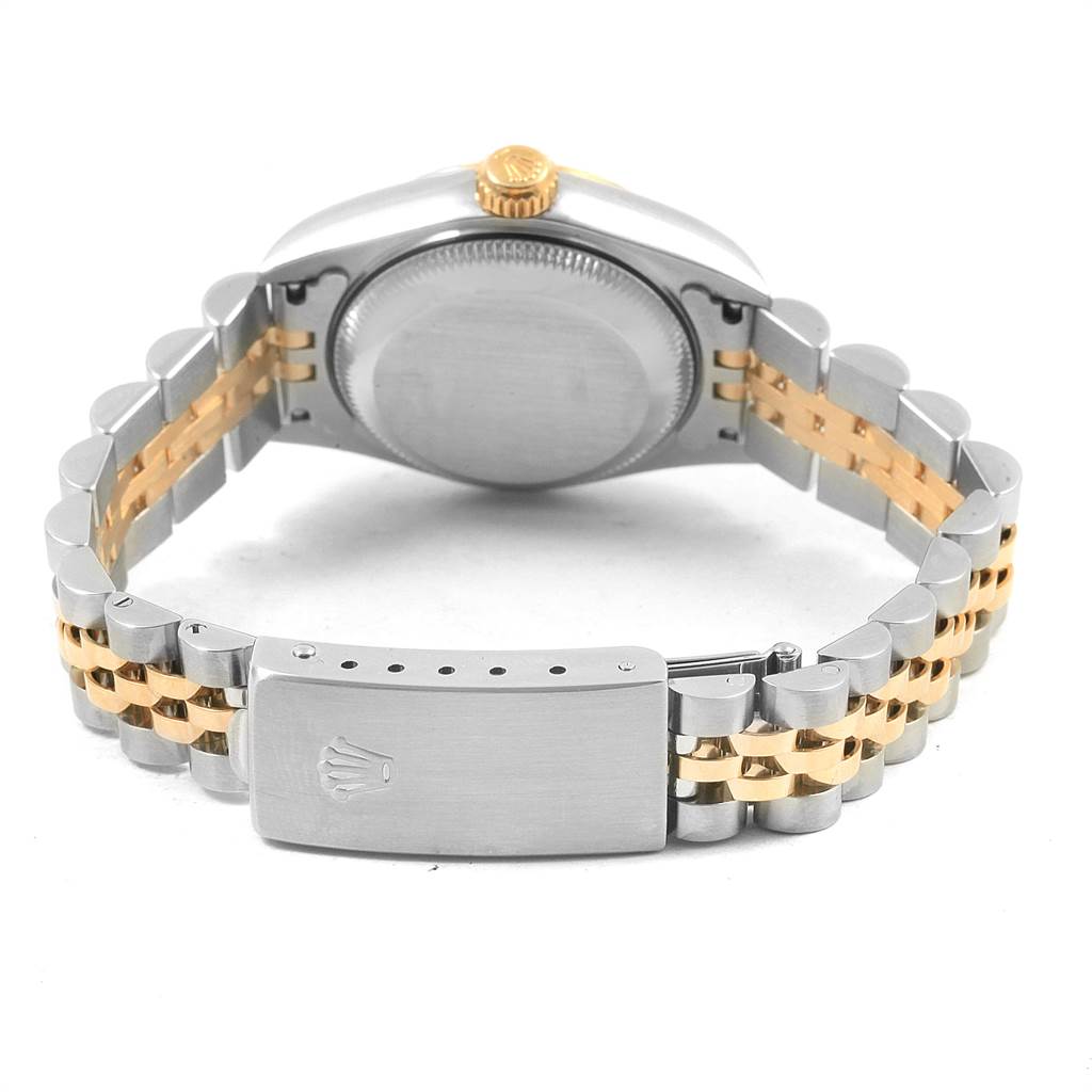 The back view of the Rolex Datejust 79173 Women's Steel and Gold (two tone) Black Dial 79173 Women's Steel and Gold (two tone) Black Dial watch shows the case back, crown, and clasp of the two-tone bracelet.