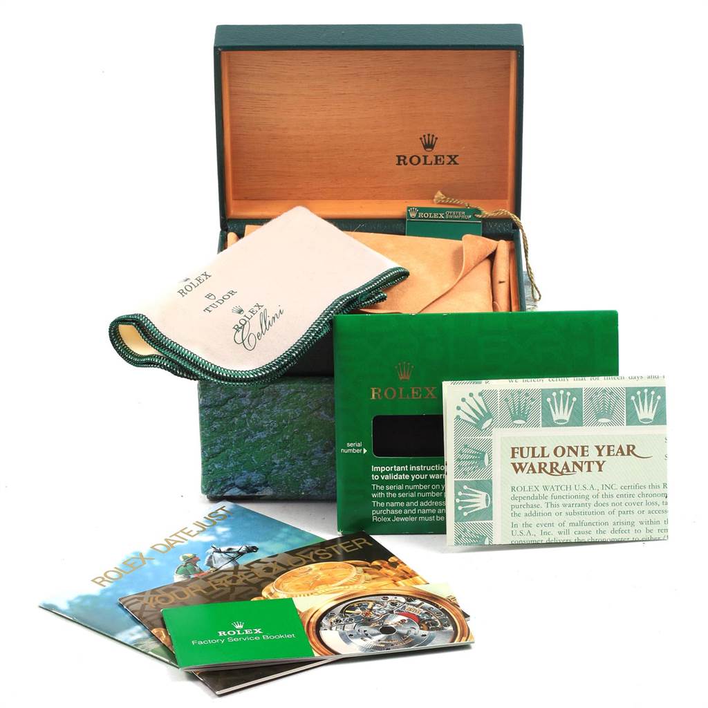 Shown are the accessories for a Rolex Datejust 69173 Women's Stainless Steel Black Dial 69173 Women's Stainless Steel Black Dial, including its box, cloth, warranty card, and booklets.