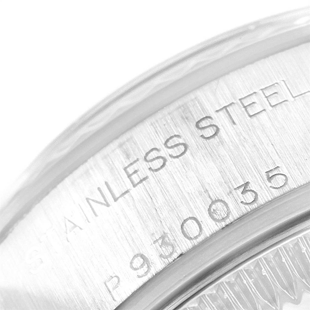 This image shows a close-up angle of the serial number and "STAINLESS STEEL" engraving on a Rolex Datejust 79174 Women
s Stainless Steel Pink Dial 79174 Women
s Stainless Steel Pink Dial watch case.
