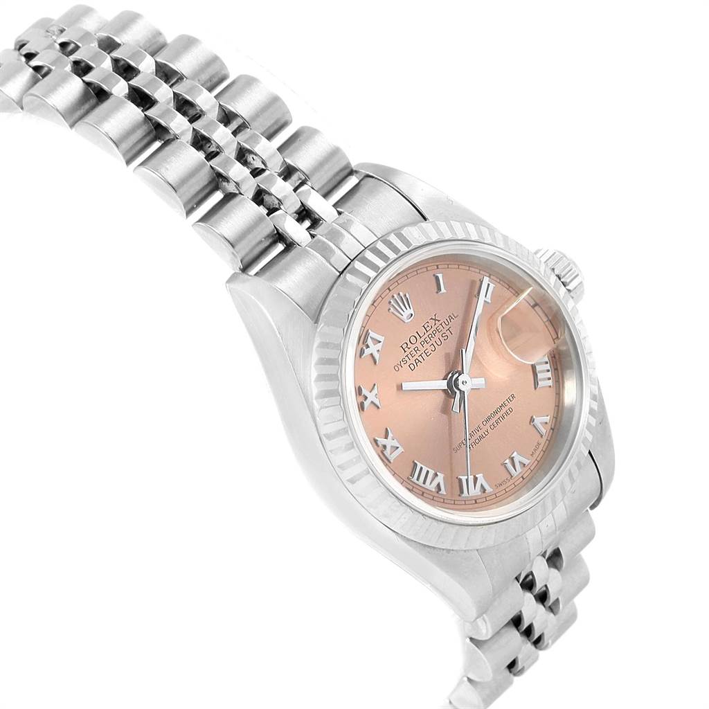The image shows a side-angle view of the Rolex Datejust 79174 Women
s Stainless Steel Pink Dial 79174 Women
s Stainless Steel Pink Dial watch, featuring its bracelet, bezel, crown, and face with Roman numerals.