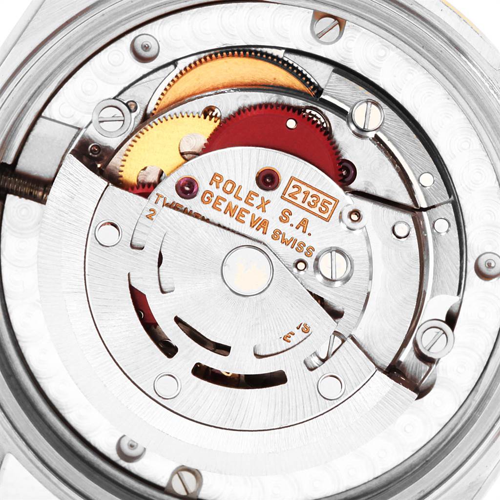 This image shows the internal movement mechanism of a Rolex Datejust 68273 Women's Steel and Gold (two tone) Champagne Dial 68273 Women's Steel and Gold (two tone) Champagne Dial watch, focusing on the gears and engraving.