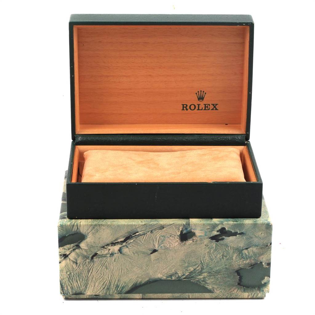 The image shows an open wooden Rolex box, likely for the Datejust model, with its cushion inside.