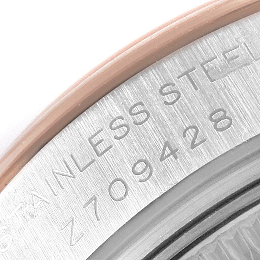 This image shows a close-up of the serial number and "STAINLESS STEEL" engraving on the back case of a Rolex Datejust 179161 Women's Steel and Gold (two tone) Pink Dial 179161 Women's Steel and Gold (two tone) Pink Dial watch.