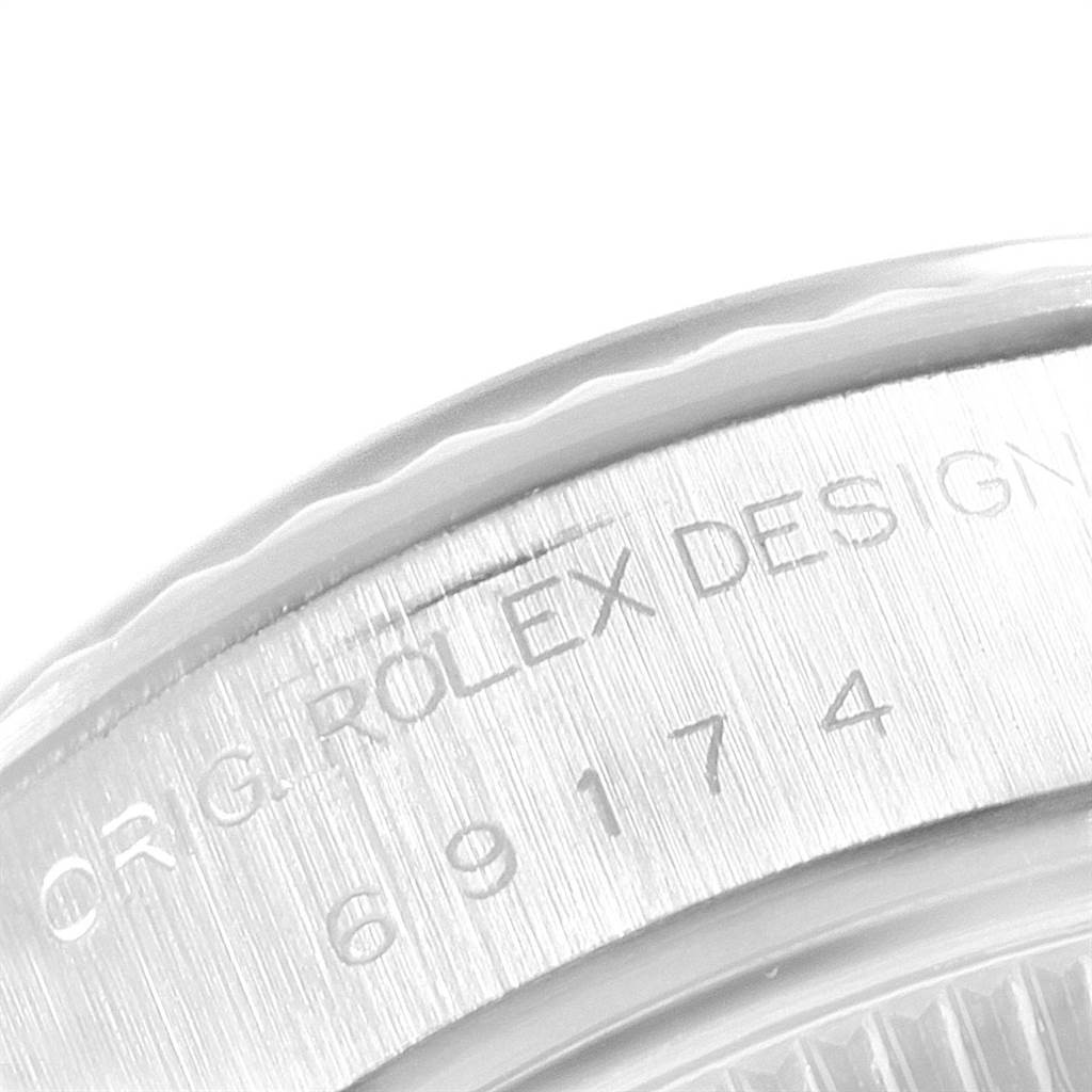Close-up of a Rolex Datejust 69174 Women's Stainless Steel Pink Dial 69174 Women's Stainless Steel Pink Dial model, showing the side with engraving "ROLEX DESIGN" and the model number "69174."
