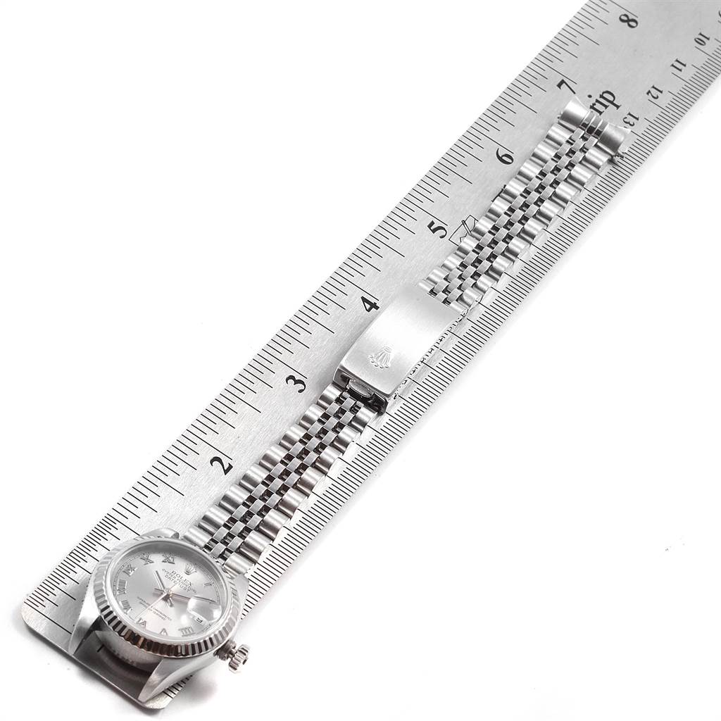 The image shows a Rolex Datejust 79174 Women's Stainless Steel Silver Dial 79174 Women's Stainless Steel Silver Dial watch laid flat against a ruler, highlighting its bracelet and clasp from a top-down angle.
