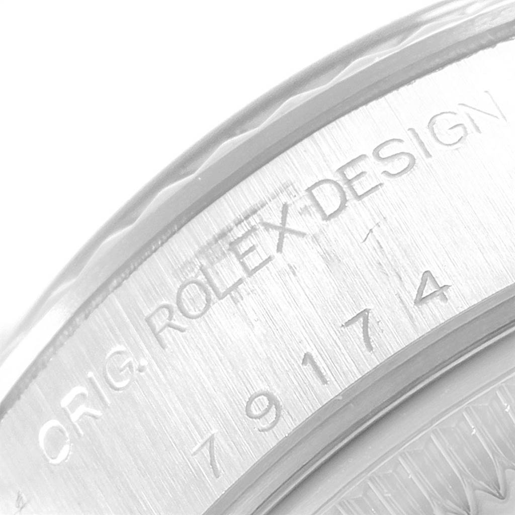 The image shows a close-up of the side of the casing for a Rolex Datejust 79174 Women's Stainless Steel Silver Dial 79174 Women's Stainless Steel Silver Dial watch, highlighting the engraved model and design number.
