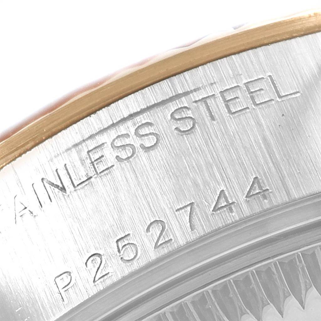 The image shows a close-up of the back case of a Rolex Datejust 79173 Women's Stainless Steel Champagne Dial 79173 Women's Stainless Steel Champagne Dial watch, highlighting its stainless steel marking and serial number.