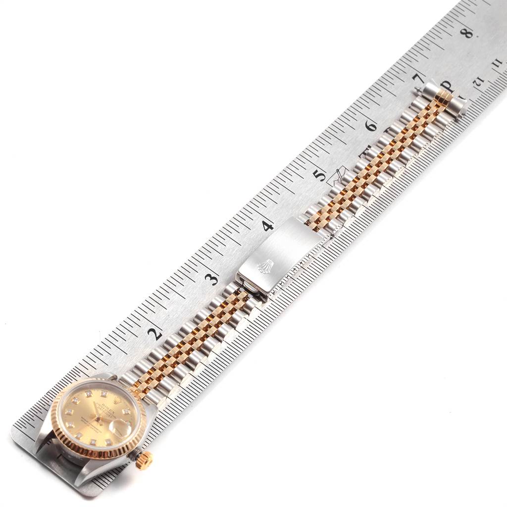 The image shows a Rolex Datejust 79173 Women's Stainless Steel Champagne Dial 79173 Women's Stainless Steel Champagne Dial watch with a two-tone bracelet, laid flat alongside a ruler for measurement.
