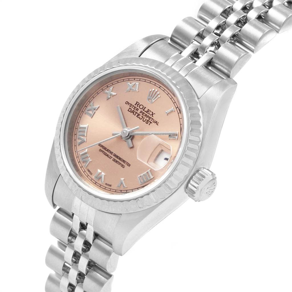 The image shows a Rolex Datejust 79174 Women
s Stainless Steel Pink Dial 79174 Women
s Stainless Steel Pink Dial watch from a slightly angled side view, highlighting its dial, crown, and part of the bracelet.