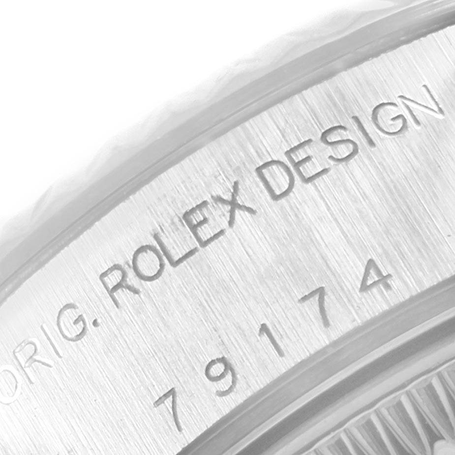 The image shows a close-up of the side engraving on a Rolex Datejust 79174 Women
s Stainless Steel Pink Dial 79174 Women
s Stainless Steel Pink Dial watch, featuring the model details.