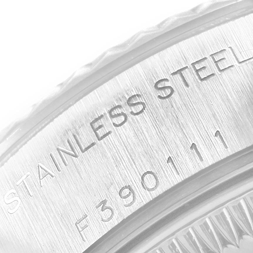 This is a close-up image of the stainless steel case back of a Rolex Datejust 79174 Women
s Stainless Steel Pink Dial 79174 Women
s Stainless Steel Pink Dial watch, showing engraved text and numbers.