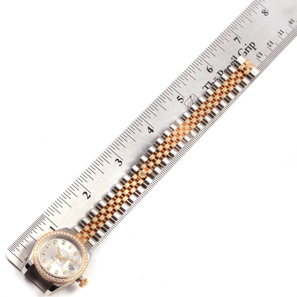 The image shows a Rolex Datejust 179383 Women
s Steel and Gold (two tone) Silver Dial 179383 Women
s Steel and Gold (two tone) Silver Dial watch placed alongside a ruler, highlighting the face and bracelet of the watch.