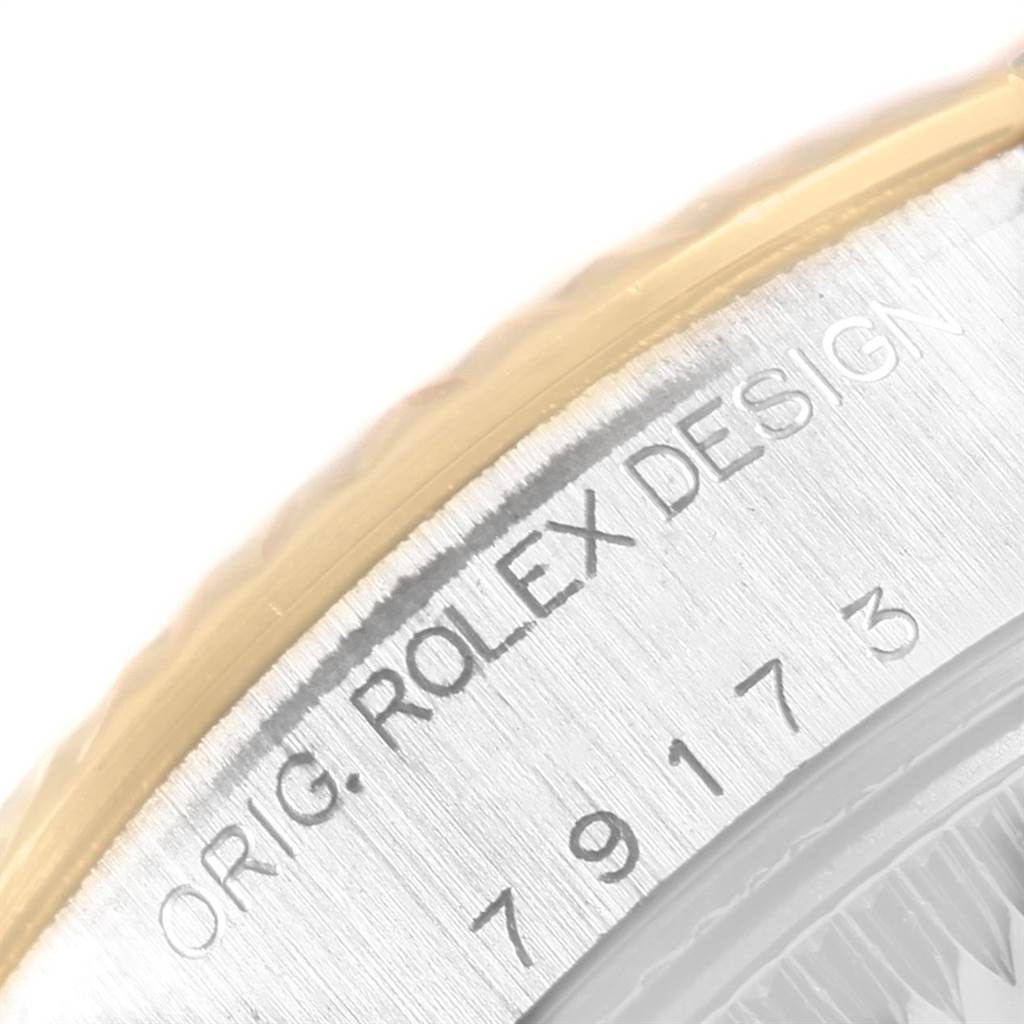The image shows a close-up of the side of the case with "ORG. ROLEX DESIGN" engraved on a Datejust model by Rolex.