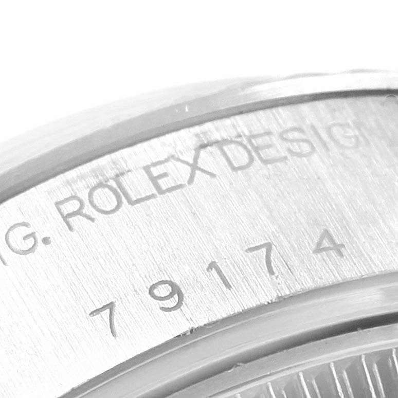 This image shows a close-up of the casing with engraved text on a Rolex Datejust 79174 Women
s Stainless Steel Silver Dial 79174 Women
s Stainless Steel Silver Dial watch.