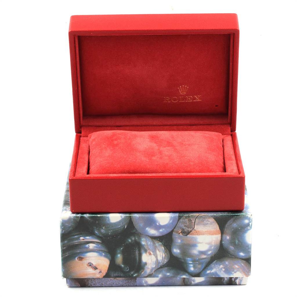 This image shows the open box of a Rolex Datejust 79174 Women
s Stainless Steel Silver Dial 79174 Women
s Stainless Steel Silver Dial watch, featuring a red interior with the brand logo visible.