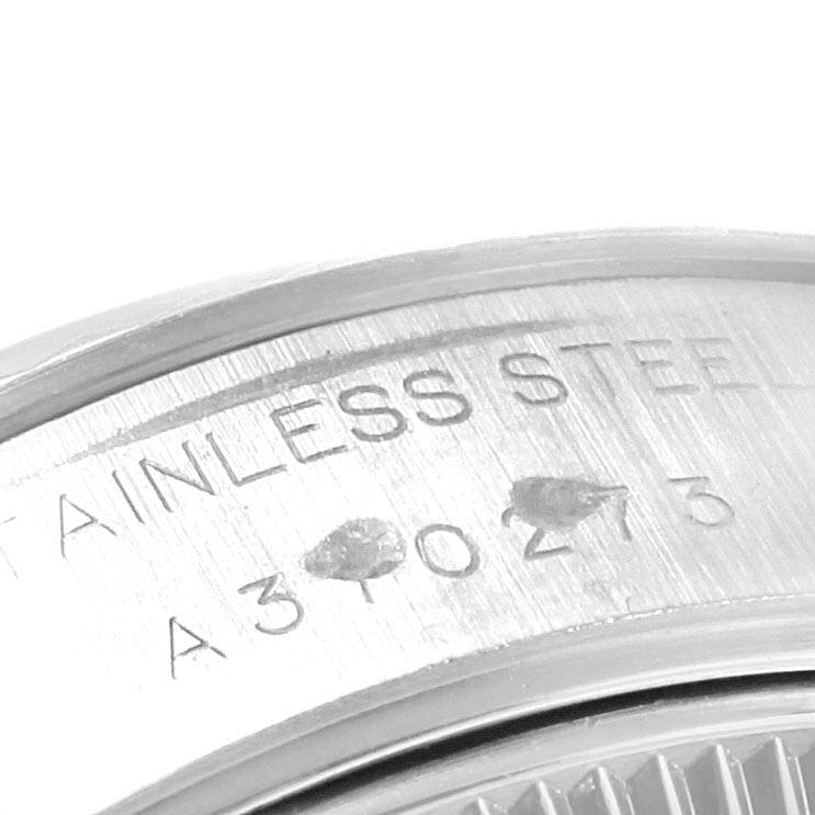 This close-up image shows the serial number and "STAINLESS STEEL" engraving on the case back of a Rolex Datejust 79174 Women's Stainless Steel Silver Dial 79174 Women's Stainless Steel Silver Dial watch.